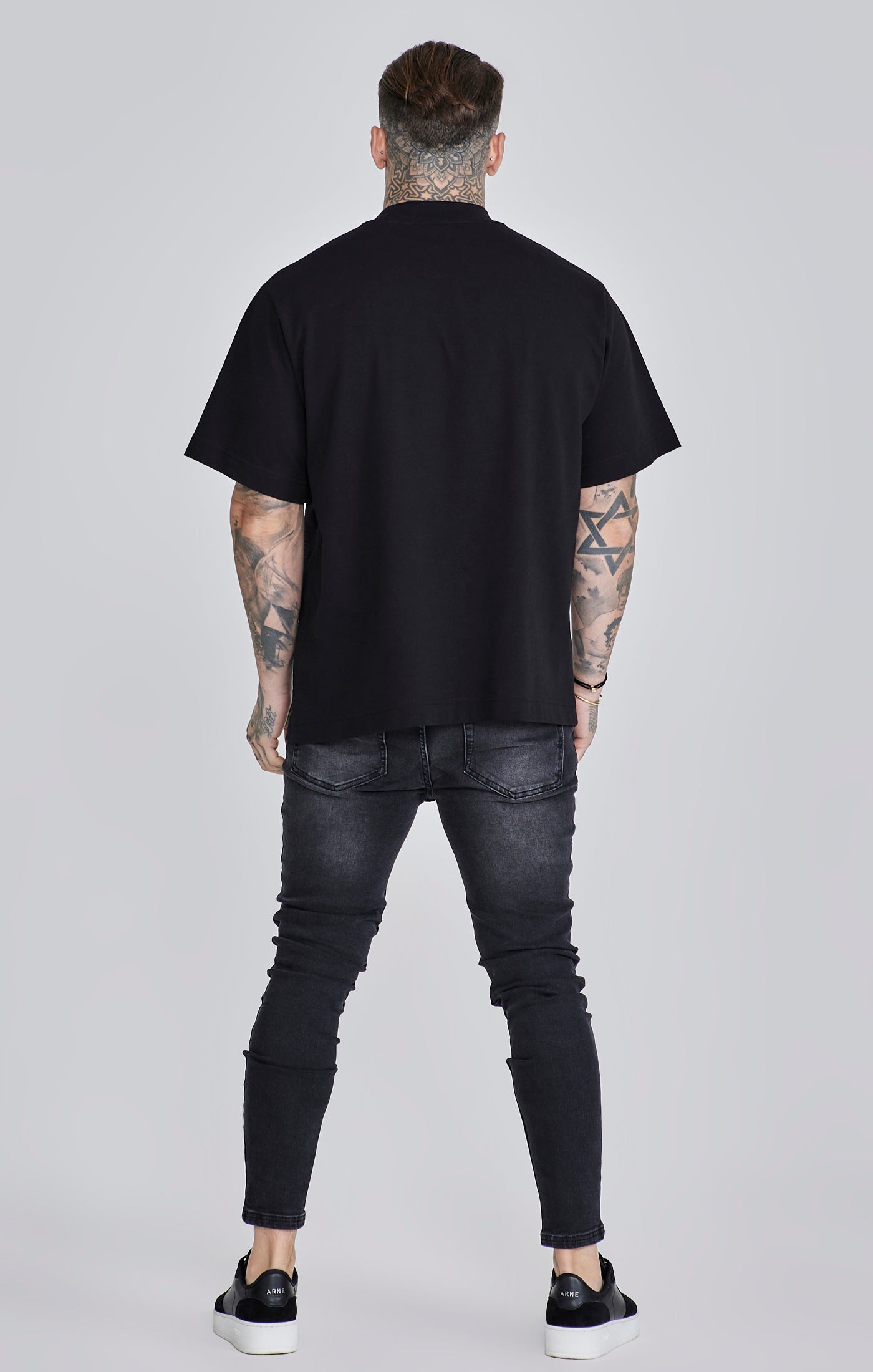Jeans skinny en noir délavé Jeans SikSilk