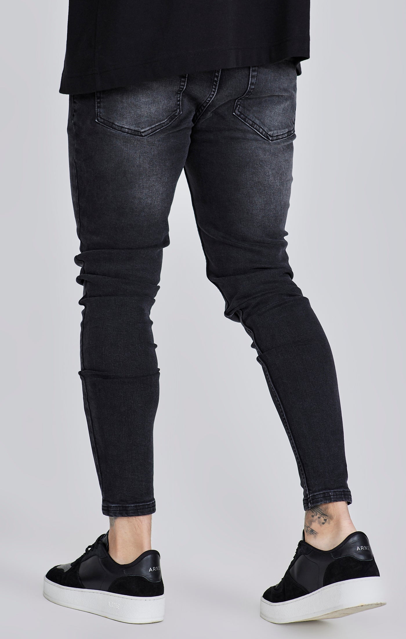 Jeans skinny en noir délavé Jeans SikSilk